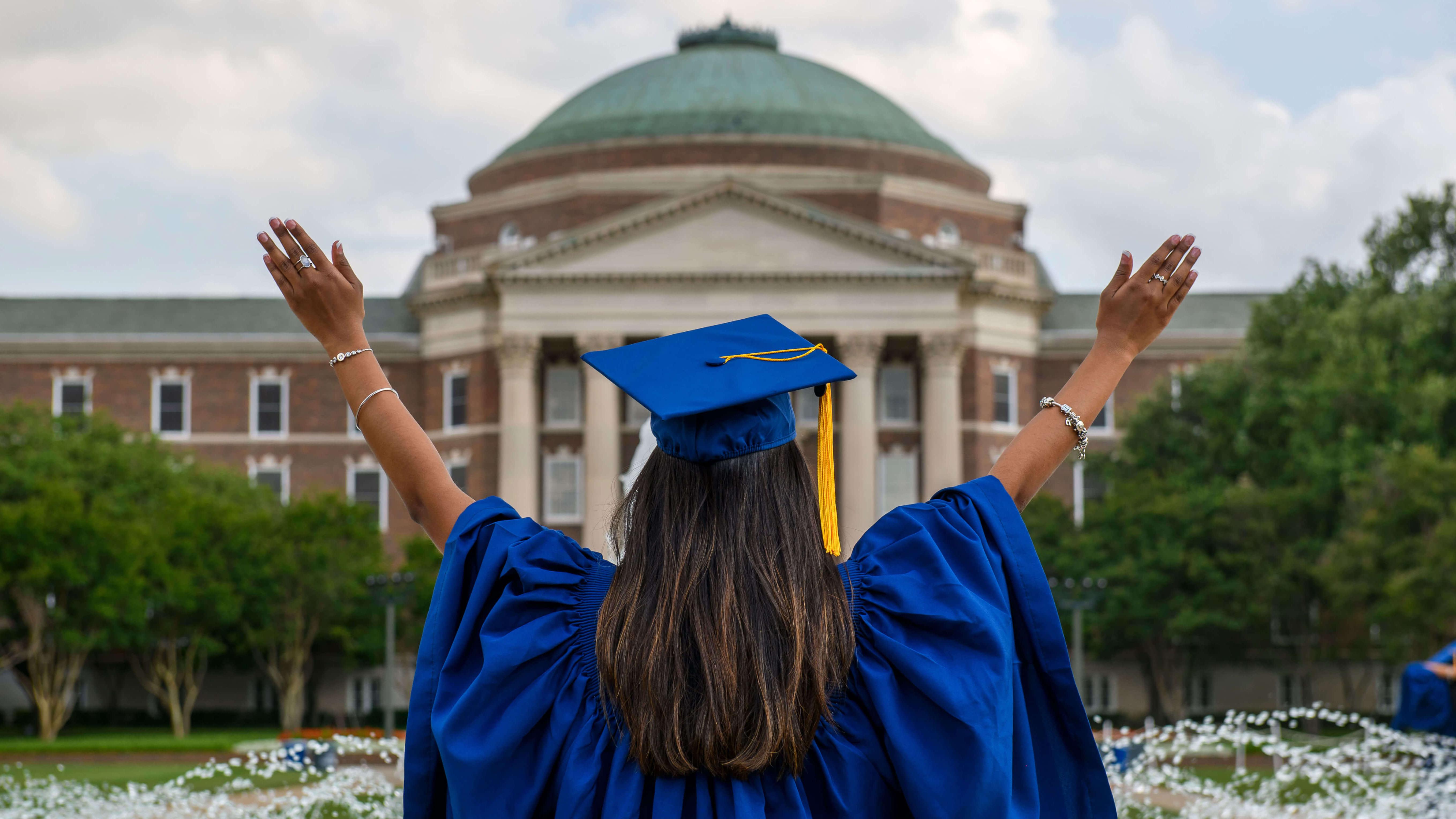 Graduate in front of fountain