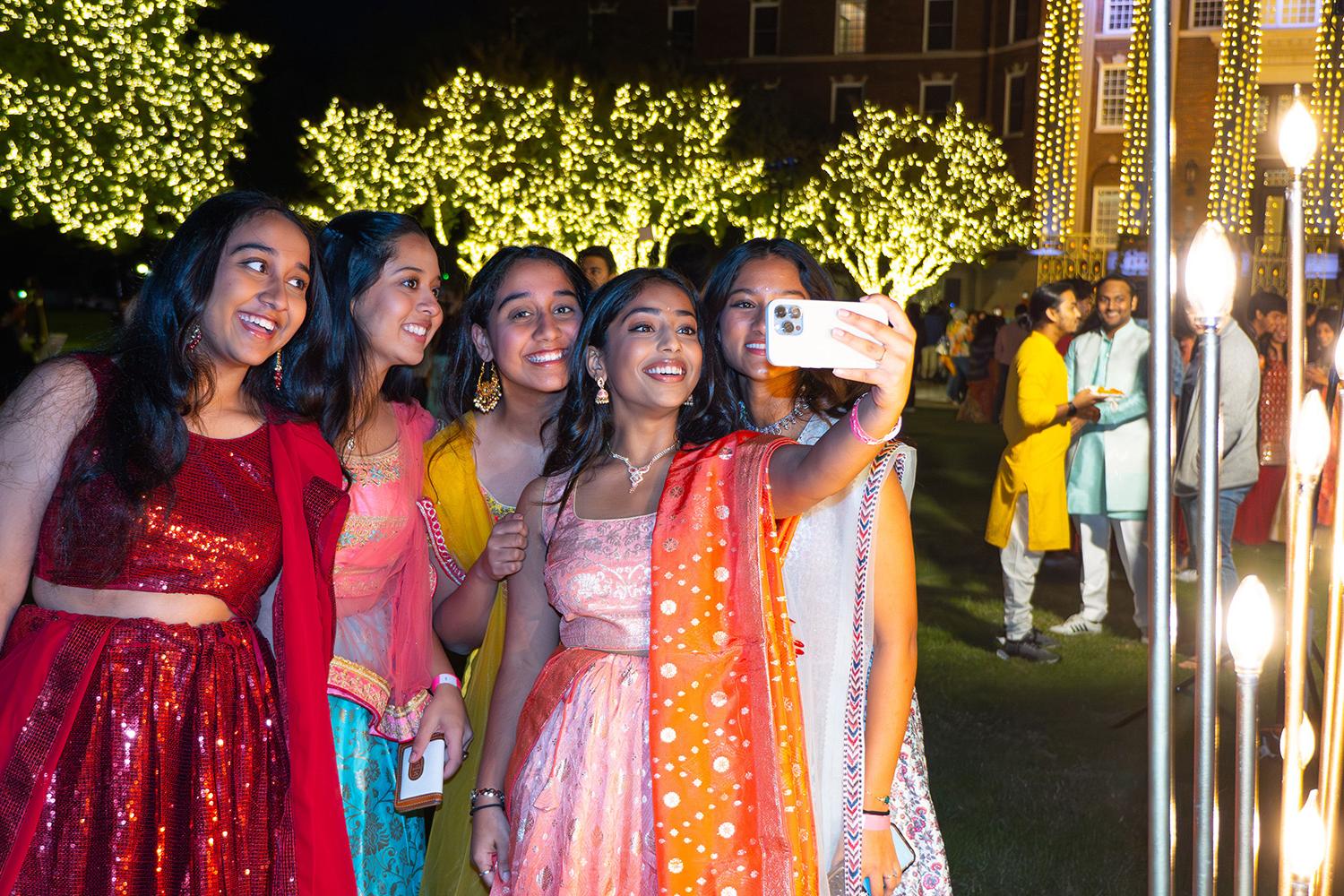 Students pose for a selfie at the Diwali festival.