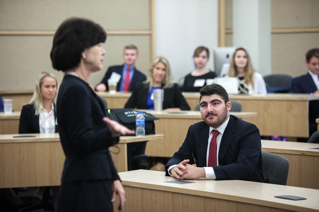 student listens to instructor at smu cox