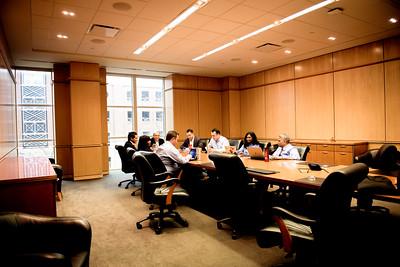 Photo of people around a table, strategizing at SMU Cox